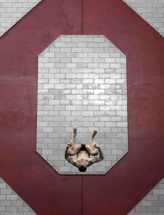 Ohio State diver Quinlan DeVal completes an inward 3-1/2 dive on the 3-meter springboard during the NCAA Zone C diving meet at the McCorkle Aquatic Pavilion in Columbus.    (Adam Cairns / The Columbus Dispatch)